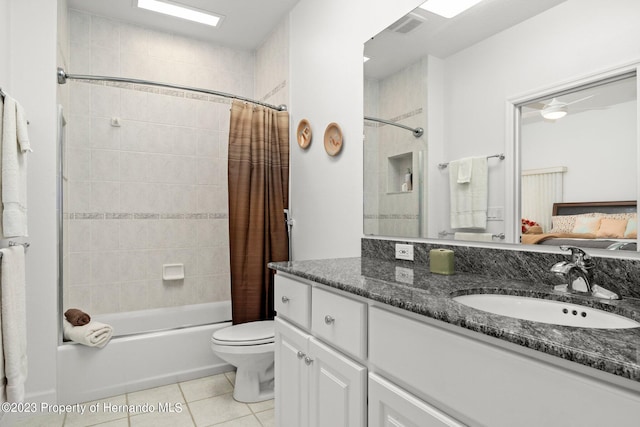 full bathroom with vanity, shower / tub combo with curtain, tile patterned floors, and toilet