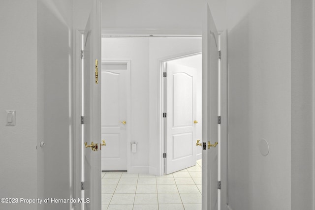 corridor featuring light tile patterned floors