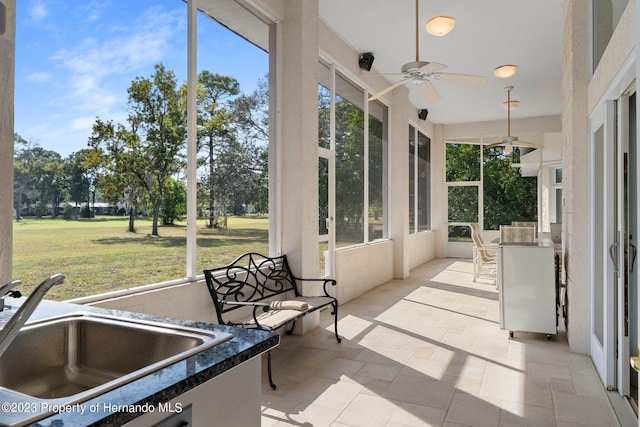 sunroom / solarium with sink and ceiling fan