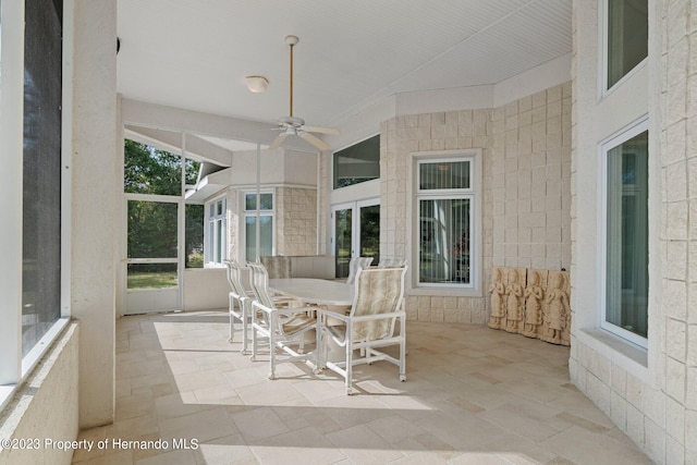 sunroom featuring ceiling fan