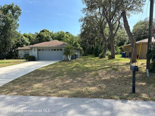 view of front of property with a front yard and a garage