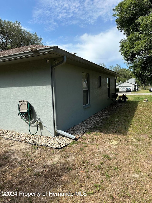 view of side of home featuring a lawn