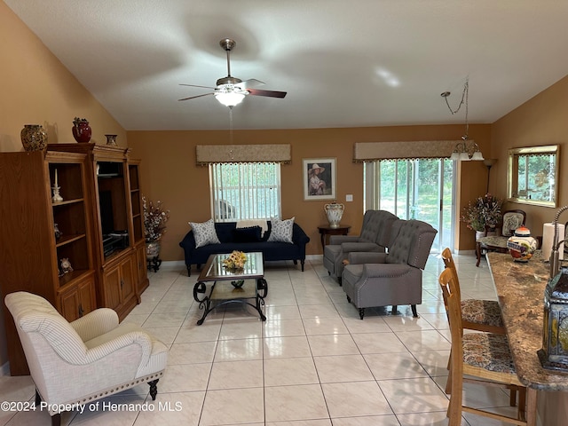 tiled living room featuring ceiling fan, lofted ceiling, and a wealth of natural light