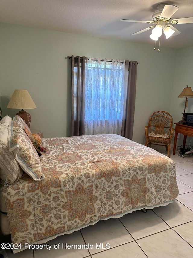 tiled bedroom with ceiling fan