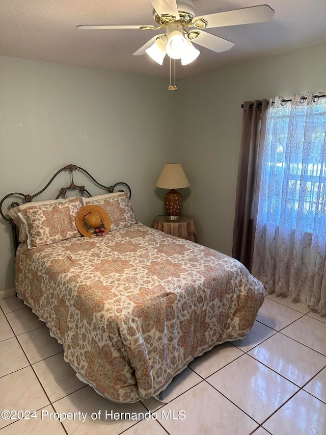 tiled bedroom with ceiling fan