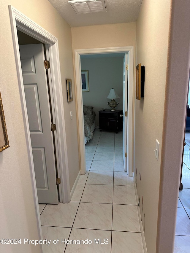 hallway featuring light tile patterned floors