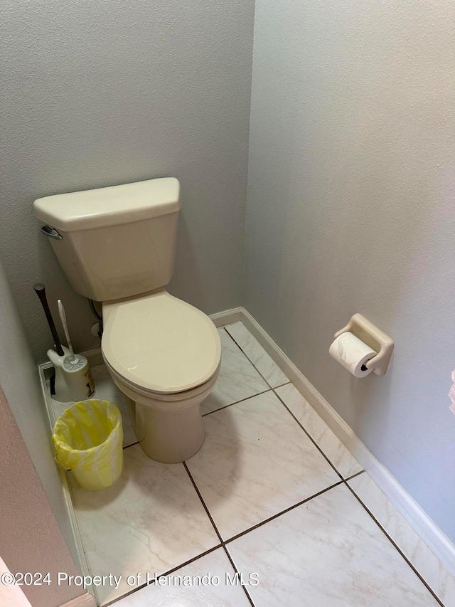 bathroom with tile patterned flooring and toilet