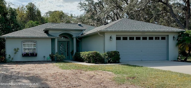 ranch-style house featuring a garage