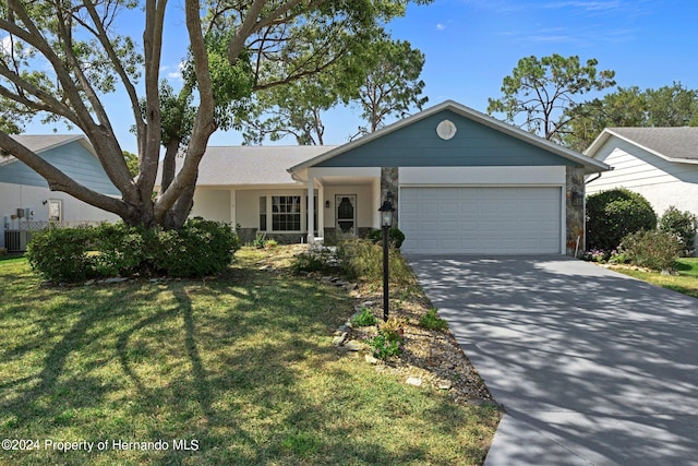 ranch-style house with a garage and a front yard