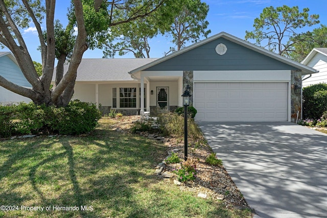 single story home featuring a garage and a front yard