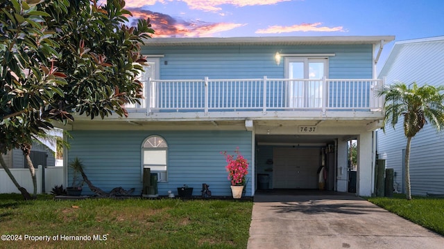 view of front of house with a balcony and a carport