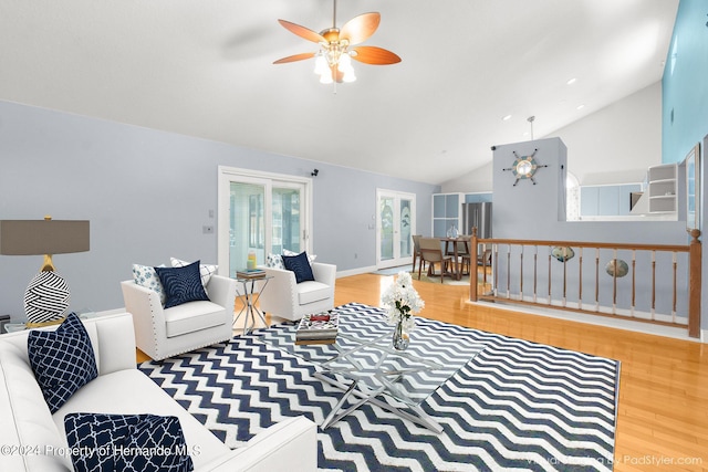 living room with hardwood / wood-style flooring, high vaulted ceiling, and ceiling fan