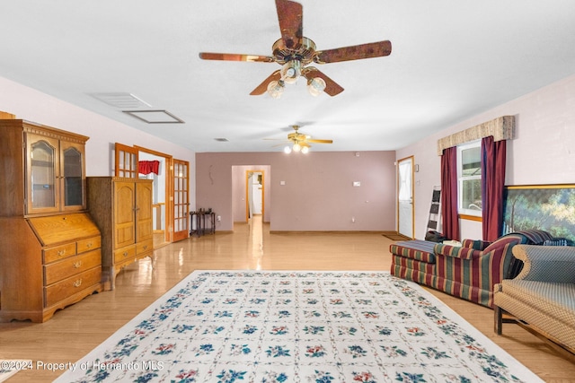 living room featuring light hardwood / wood-style floors and ceiling fan