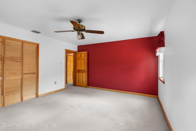 unfurnished bedroom featuring a closet, ceiling fan, and carpet floors