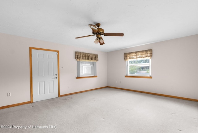 spare room featuring ceiling fan and carpet floors