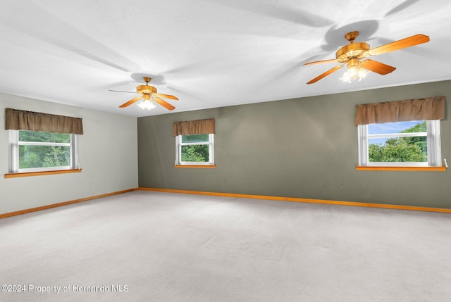 unfurnished room with carpet and ceiling fan