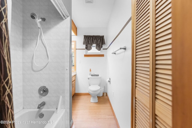 full bathroom featuring shower / bath combination with curtain, a closet, wood finished floors, and toilet