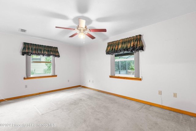 unfurnished room with carpet, plenty of natural light, and ceiling fan