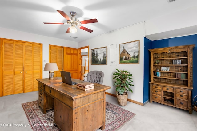 office space featuring a ceiling fan, visible vents, and baseboards