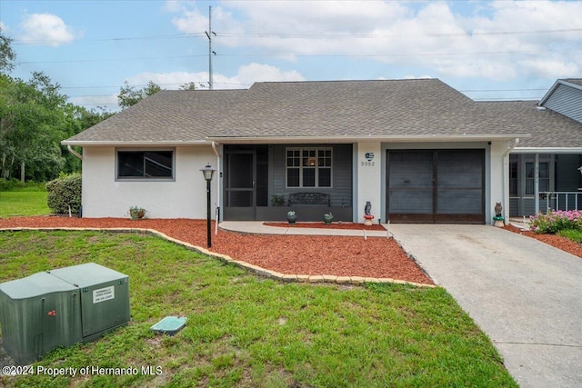 ranch-style home featuring a garage and a front yard