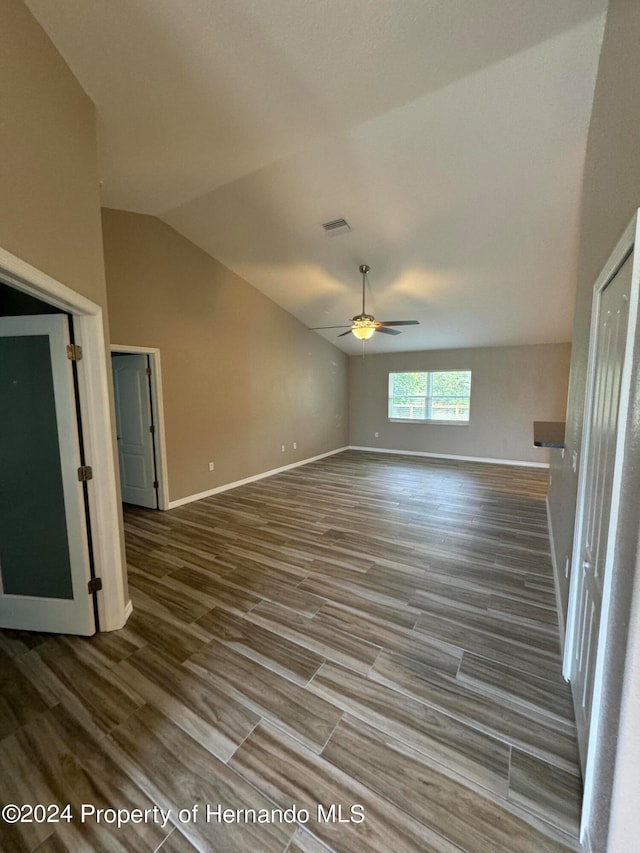 empty room featuring ceiling fan, hardwood / wood-style floors, and lofted ceiling