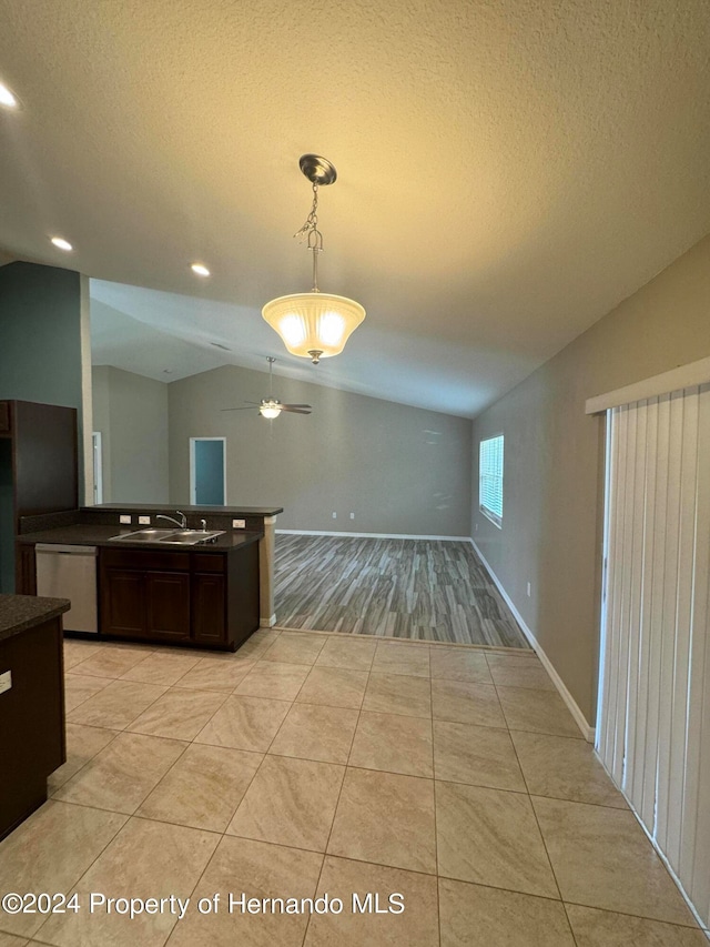 interior space featuring dark brown cabinets, sink, decorative light fixtures, dishwasher, and lofted ceiling