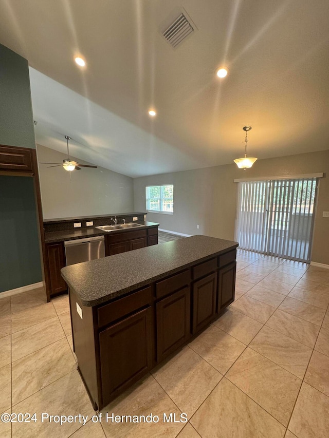 kitchen featuring stainless steel dishwasher, vaulted ceiling, ceiling fan, pendant lighting, and a center island