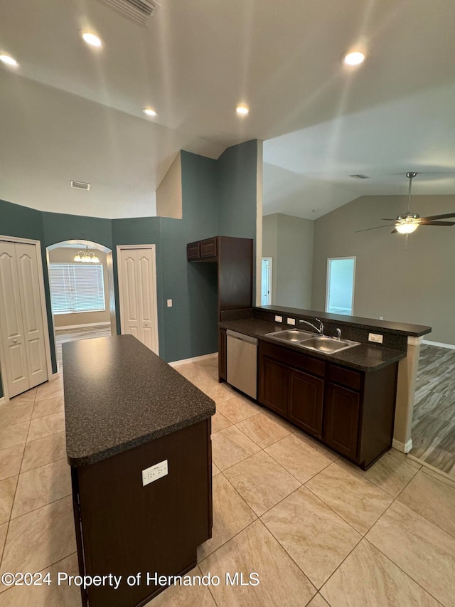 kitchen featuring ceiling fan, sink, a center island, stainless steel dishwasher, and lofted ceiling