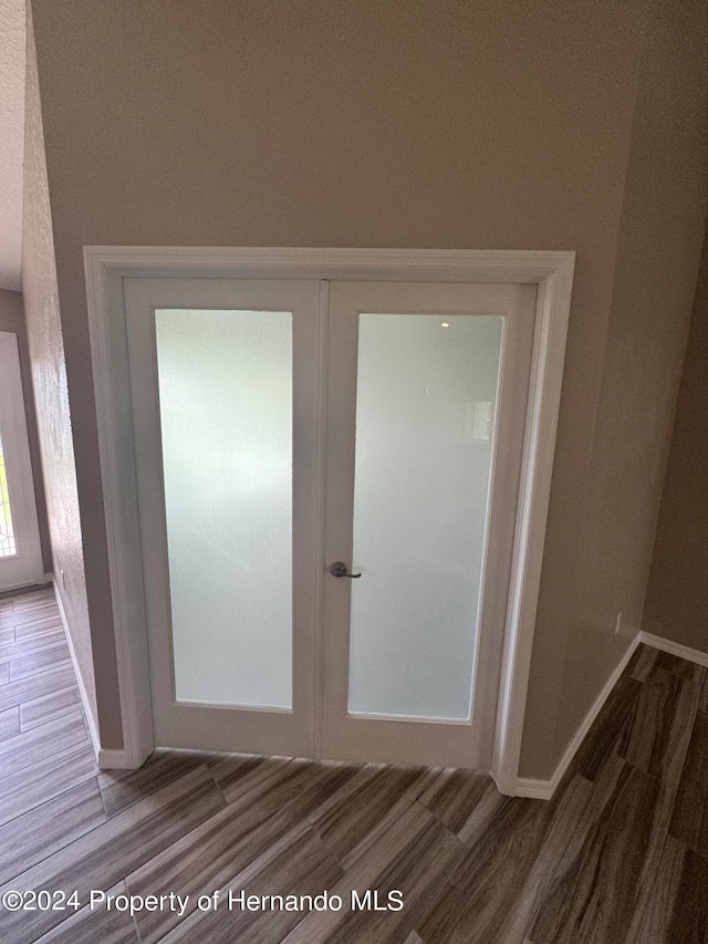 interior details featuring wood-type flooring and french doors