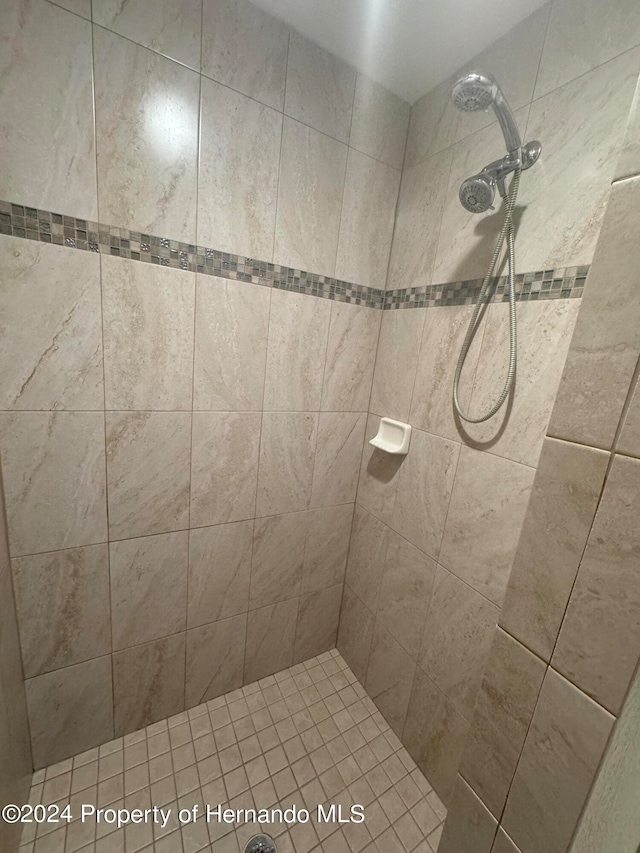 bathroom with a tile shower