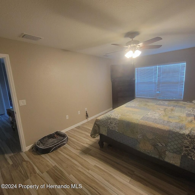 bedroom featuring ceiling fan and wood-type flooring