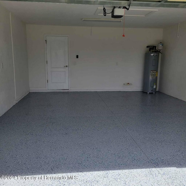 garage featuring water heater and a garage door opener