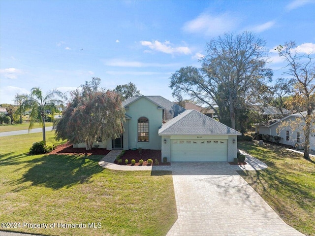 view of front facade with a garage and a front lawn