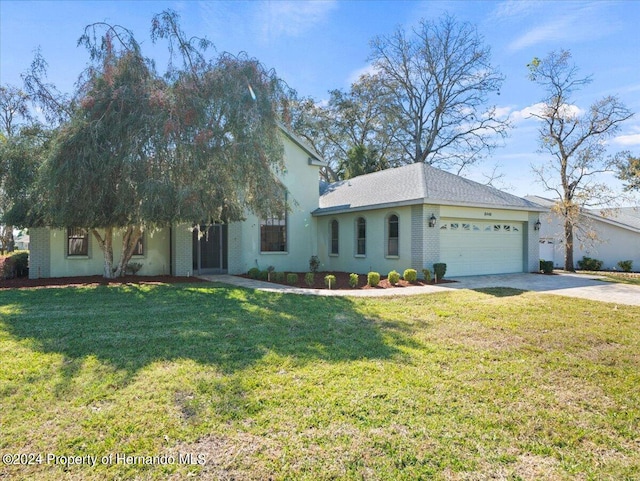 view of front of home with a garage and a front yard