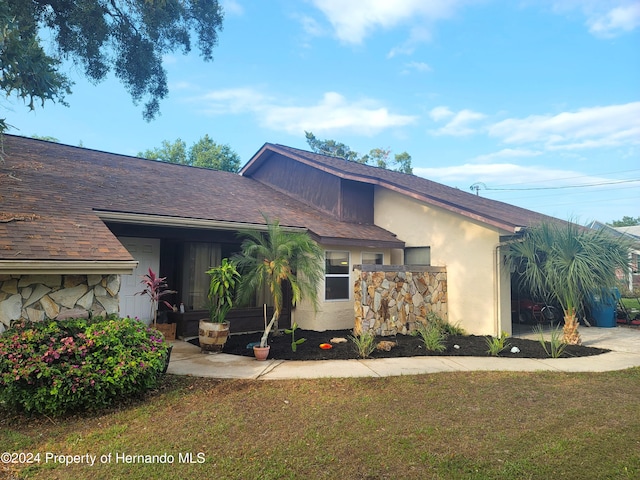 ranch-style house with a front lawn