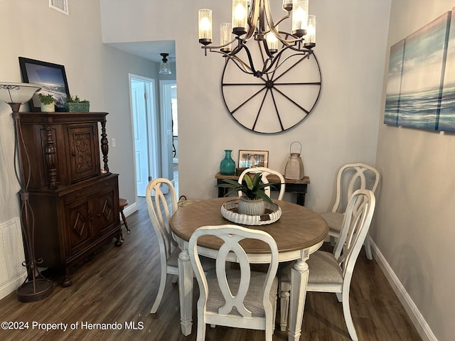 dining area featuring a chandelier and dark hardwood / wood-style flooring