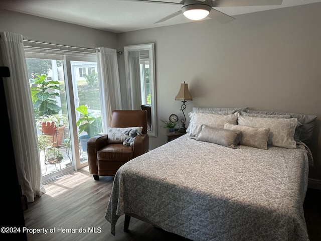 bedroom featuring ceiling fan, access to exterior, a textured ceiling, and hardwood / wood-style floors