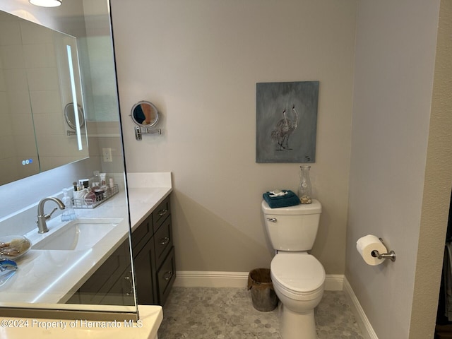 bathroom with vanity, tile patterned floors, and toilet