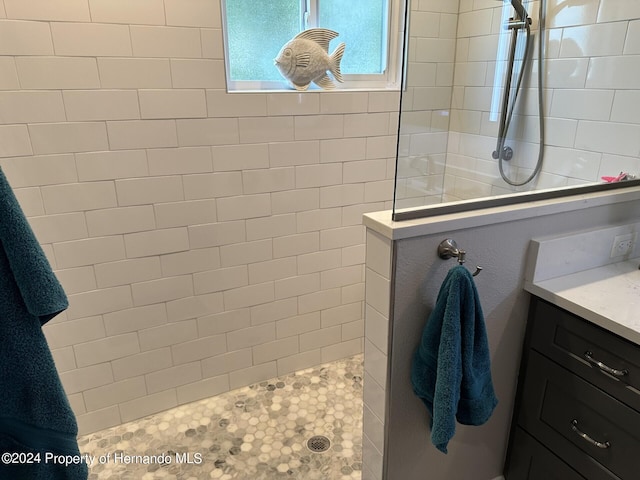 bathroom featuring vanity and a tile shower