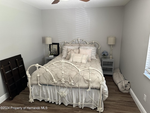 bedroom with ceiling fan and dark hardwood / wood-style flooring