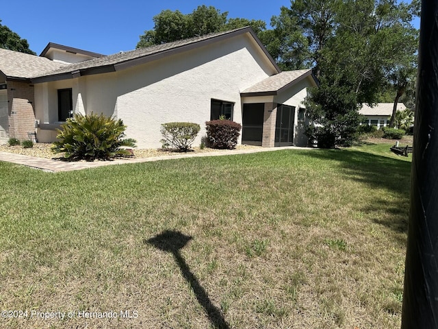 view of home's exterior featuring a lawn