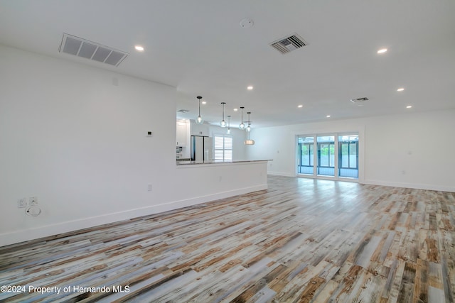 unfurnished living room with light wood-type flooring