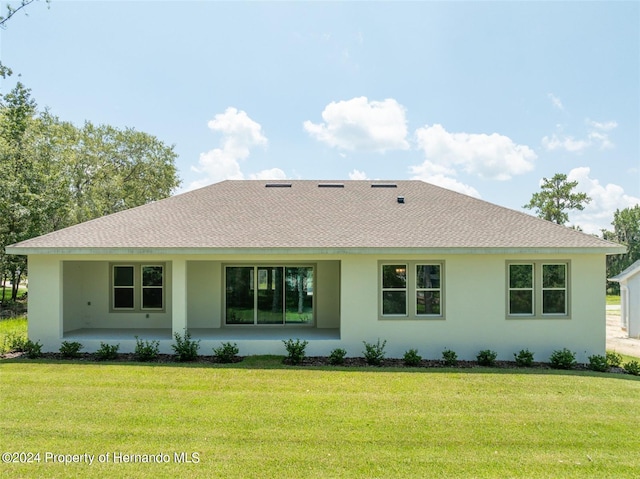 rear view of property featuring a yard