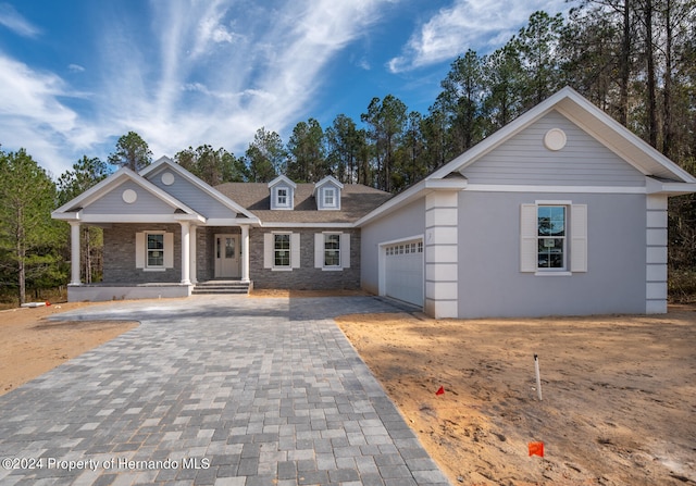 view of front of property with a garage and a porch