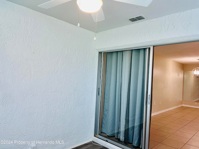 interior space featuring tile patterned flooring and ceiling fan