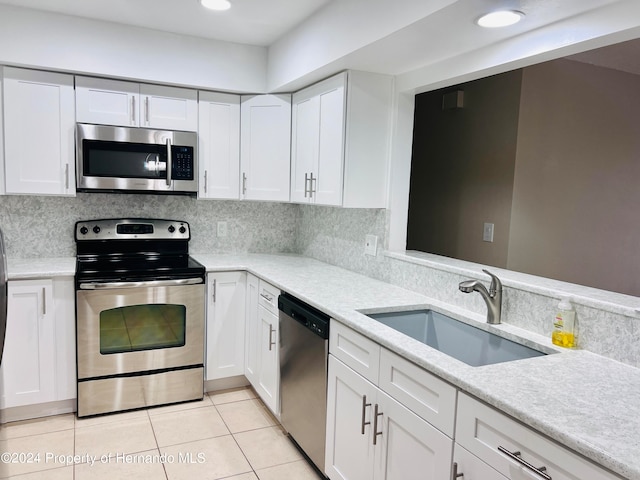 kitchen featuring white cabinetry, stainless steel appliances, sink, and tasteful backsplash