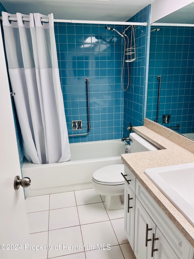 full bathroom featuring toilet, vanity, shower / bath combination with curtain, and tile patterned floors