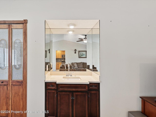 bathroom featuring vanity, lofted ceiling, and ceiling fan