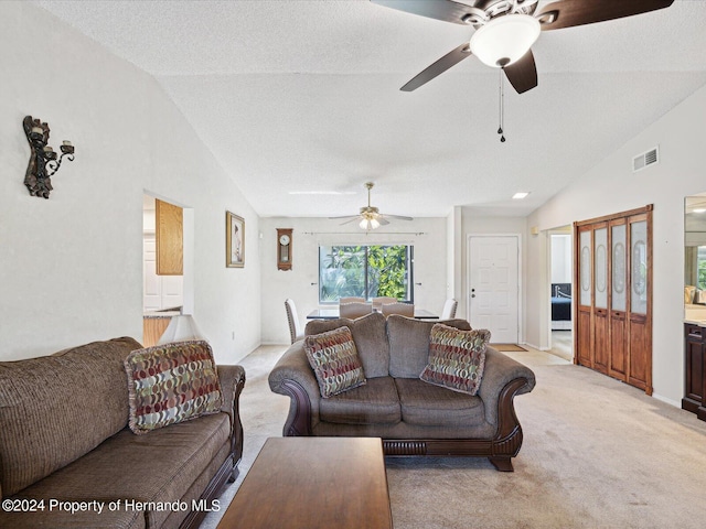 carpeted living room featuring lofted ceiling, a textured ceiling, and ceiling fan