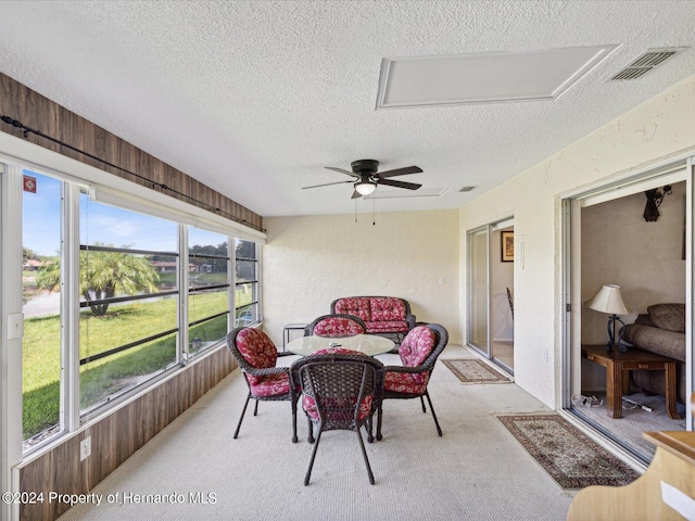 sunroom / solarium featuring ceiling fan